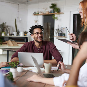 Man and woman working together on a laptop while smiling